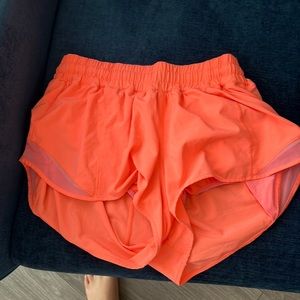 Vibrant orange/pink lululemon shorts. Size 6.